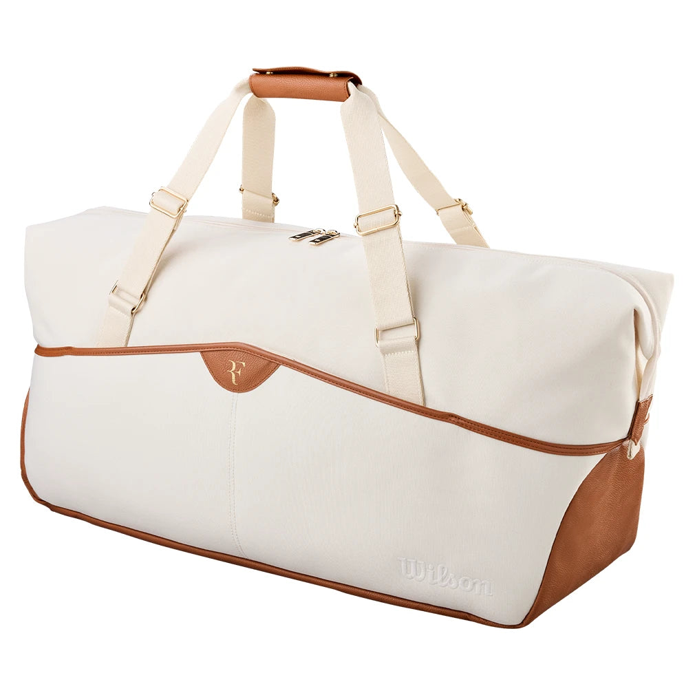 Cream Wilson RF Lawn Collection Practice Duffel Bag shown from the front with brown handles and gold hardware.